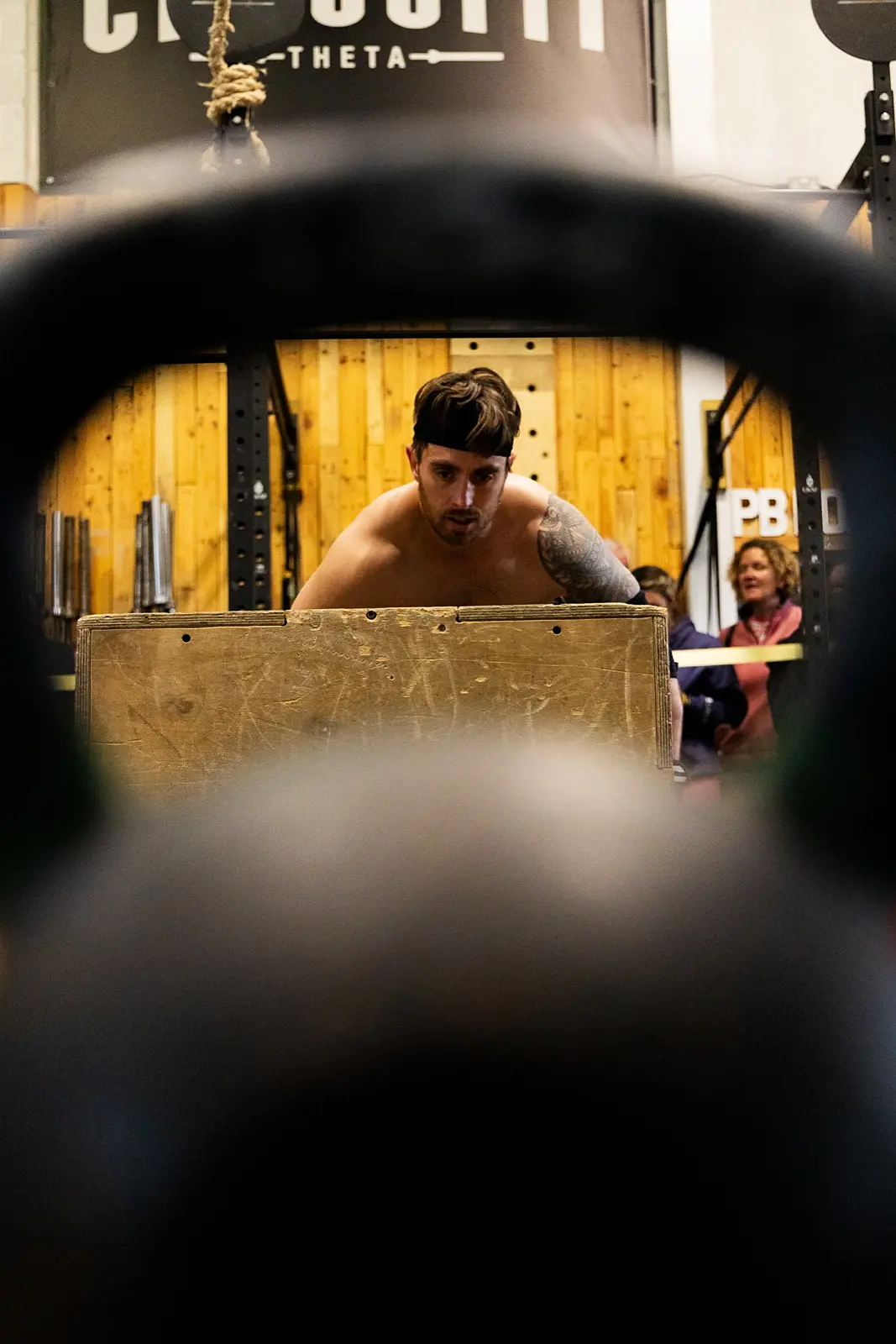 An athlete seen through the handle of a kettlebell